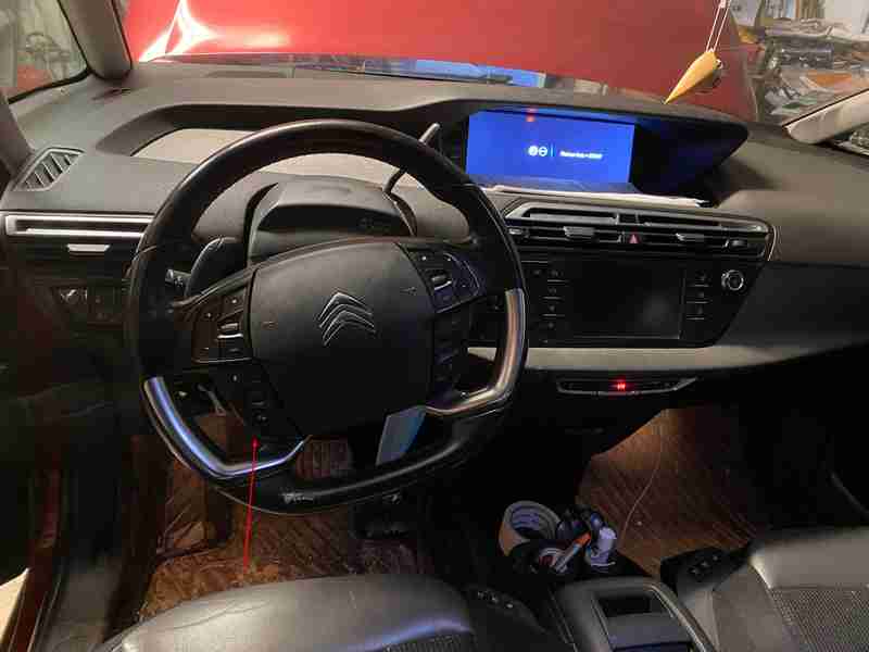 Vue de l habitacle d une Citroen C4 avec son volant et l ecran de diagnostic allume